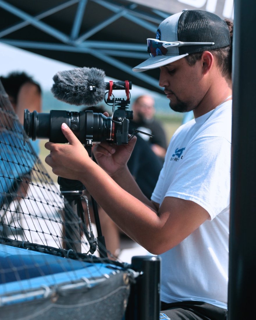 Bryan Sanchez filming courtside with a cinema camera during a Sapphire Sports Productions shoot